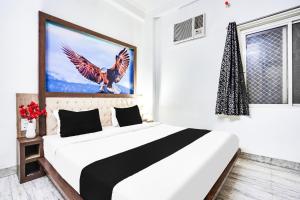 Postel nebo postele na pokoji v ubytování Super Hotel O Vaishali Nagar