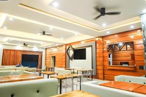 a restaurant with wooden walls and tables and chairs at The Paragon Hotel and Restaurant in Bagua