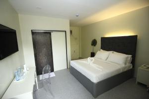 a bedroom with a bed with a black headboard at The Paragon Hotel and Restaurant in Bagua