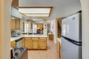 a kitchen with wooden cabinets and a white refrigerator at Spacious Pet Friendly Casita With Incredible Views in Bullhead City