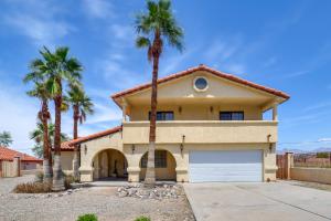 a house with palm trees in front of it at Spacious Pet Friendly Casita With Incredible Views in Bullhead City