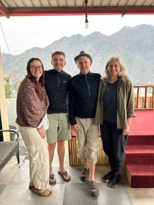 a group of people posing for a picture on a balcony at GreenDay Escapes Rishikesh in Rishīkesh