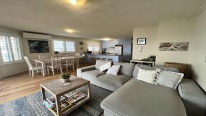 a living room with a couch and a table at Sandy Cove Unit 6 in Caloundra