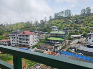 a view from a balcony of a city with buildings at Cicily Cottage in Munnar