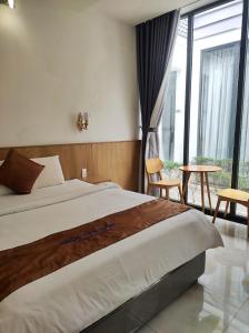 Postel nebo postele na pokoji v ubytování Ngoc Trai Xanh Bungalow