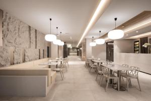 a restaurant with tables and chairs and lights at Aqua Perla Boutique Hotel in Chişinău