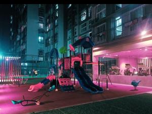 a playground in a city at night with pink lights at Residential Tranquil in Mumbai