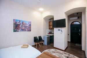 a room with a bed and a kitchen with a refrigerator at Lovely flat near the Boulevard Center of Baku in Baku