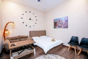 a bedroom with a bed and a clock on the wall at Lovely flat near the Boulevard Center of Baku in Baku
