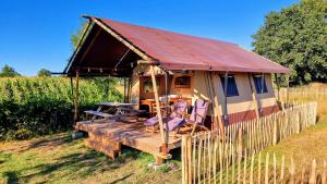 a yurt with a table and chairs in a field at Luxury Safari Tent near Veluwe in Klarenbeek