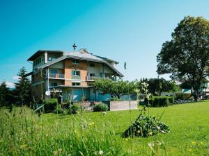 a house on a hill with a green field at - at Lake Faak KARGLHOF - Suite Mittagskogel in Faak am See