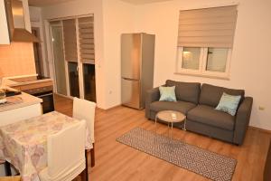 a living room with a couch and a table at Apartman Daiya in Rovinj