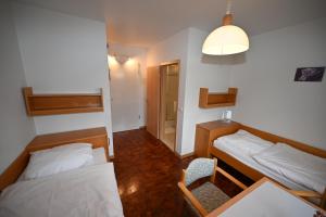 a small room with two beds and a table at Expotel Hannover Messe in Hannover