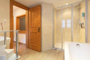 a bathroom with a shower and a glass door at Ferienhaus Ban Brösign in Umhausen +49 photos