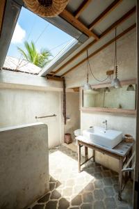y baño con lavabo blanco y mesa. en The Bingin Beach Villas' Private Villas 1, en Uluwatu