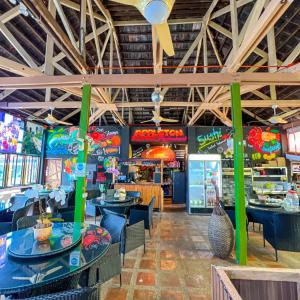 a restaurant with tables and chairs and a food court at Appleton Little Paradise Beach Resort & Restaurant REAL QUEZON in Real