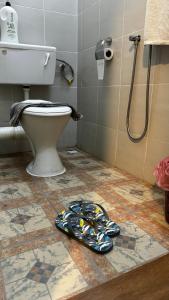 a bathroom with a toilet and a tile floor at charming 1br retreat in bayan lepas 1car park Malaysian guest only Netflix in Bayan Lepas +32 photos