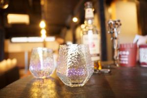two glasses sitting on top of a wooden table at Onjuku in Iwada