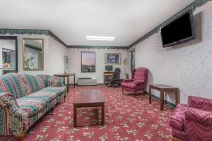a living room with a couch and a tv at Days Inn by Wyndham Royston in Royston
