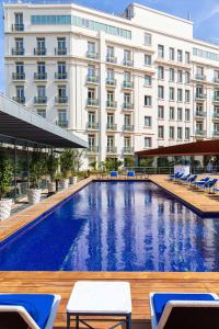 a swimming pool in front of a hotel at Hôtel Martinez, in The Unbound Collection by Hyatt in Cannes +37 photos