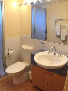 a bathroom with a white toilet and a sink at Horizons Beachfront Apartment in Port Fairy