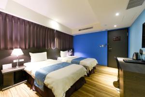 מיטה או מיטות בחדר ב-Blue Coast Hotel