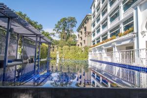 a reflection of a building in a body of water at Sabai Sabai Chiangmai in Chiang Mai