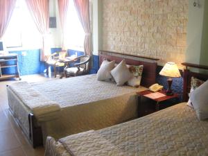 Tempat tidur dalam kamar di Sunny C Hotel