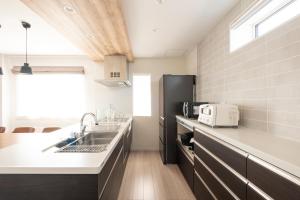 a kitchen with a sink and a counter at Tokuno Zoo Street in Asahikawa