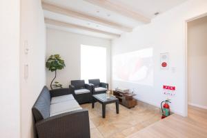 a living room with a couch and a white wall at Tokuno Zoo Street in Asahikawa +50 photos