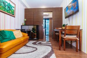 a living room with a couch and a dining room table at Boutique Air Retreat Relax Laugh Swim Gym Car Park 1767 in Manila