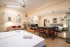 a large room with two beds and a living room at Syntagma square 1 bedrm 4 persons apartment by MPS in Athens