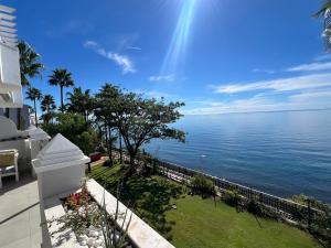 a view of the ocean from the balcony of a house at Estepona Beach Front Apartment with Stunning Sea Views in Estepona