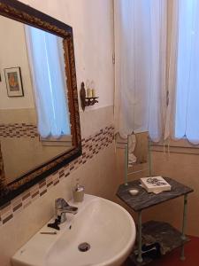 a bathroom with a sink and a mirror at La Maison Rouge in Crespellano +35 photos
