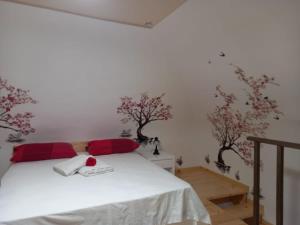 a bedroom with a bed with trees on the wall at Il borgo nuovo, Pompei in Terzigno