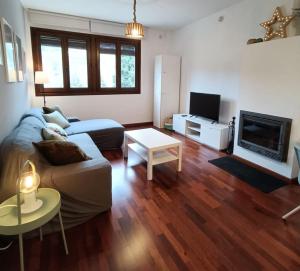 a living room with a couch and a tv at Carmen y Em's Retreat in Rubielos de Mora