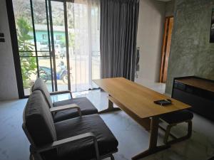 a living room with a couch and a wooden table at NatureHome RimKhlong in Ban Bang Rin (1)