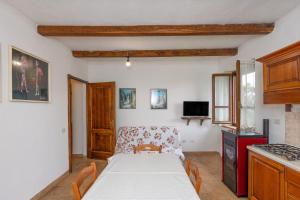 a kitchen with a table and a couch in a room at Montepozzalino in Massa Marittima