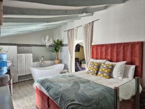 a bedroom with a large bed and a bath tub at Casa Roberto Altea in Altea