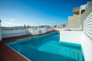 a swimming pool on the roof of a building at Day's Inn Hotel and Residence in Sliema