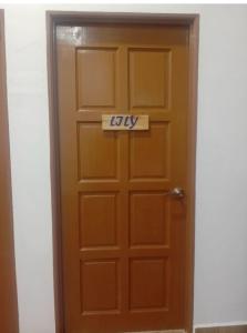 a wooden door with a way sign on it at Noorsyah Roomstay Kangar Jaya in Kangar