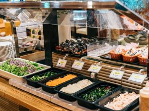 a buffet line with different types of food in trays at Hearton Hotel Kita Umeda in Osaka