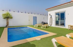 a swimming pool in the yard of a house at Villa Barry Swimming Pool, Amazing Sea Views, Bar in Tarajalejo