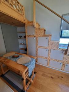 a room with a bunk bed and some drawers at Mountain view Bespoke tiny home in Plettenberg Bay