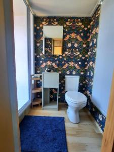 a bathroom with a toilet and a mirror at Mountain view Bespoke tiny home in Plettenberg Bay +15 photos