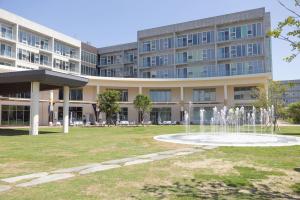 an exterior view of a building with a fountain at Phoenix Island in Seogwipo