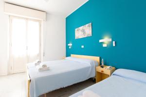 Postel nebo postele na pokoji v ubytování Hotel Lucciola