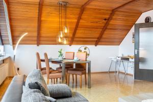 a living room with a table and a couch at Fewo Naturblick in Wiesenthau