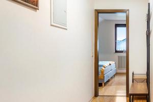 a hallway with a mirror and a bed in a room at Fewo Naturblick in Wiesenthau
