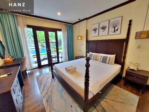 a bedroom with a large bed and a balcony at Sunrise Hotel Luang Prabang Mekong river in Luang Prabang